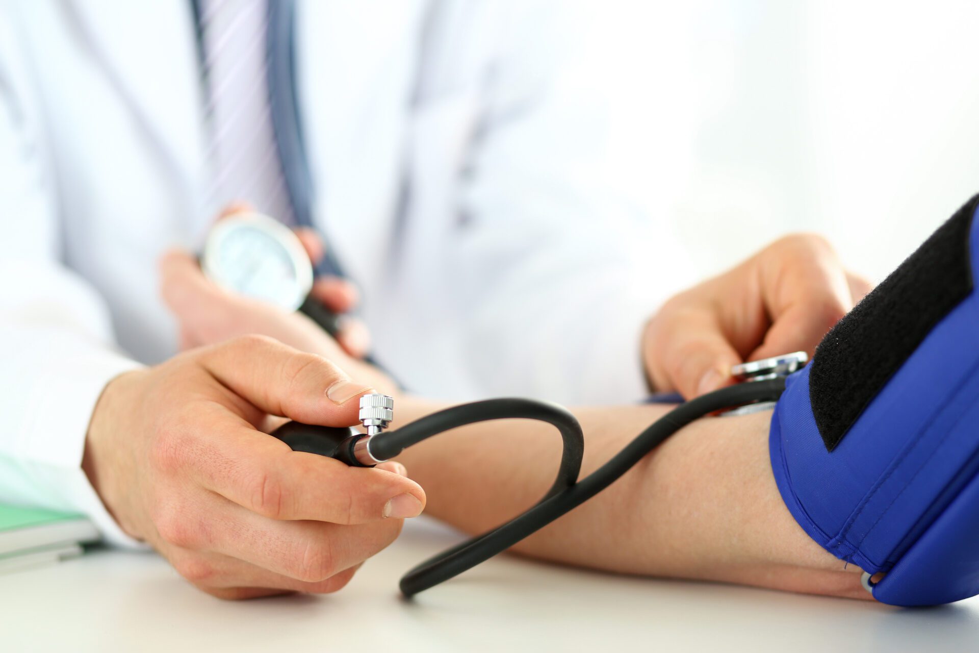 Close-up of specialist's hands performing blood pressure check procedure with 